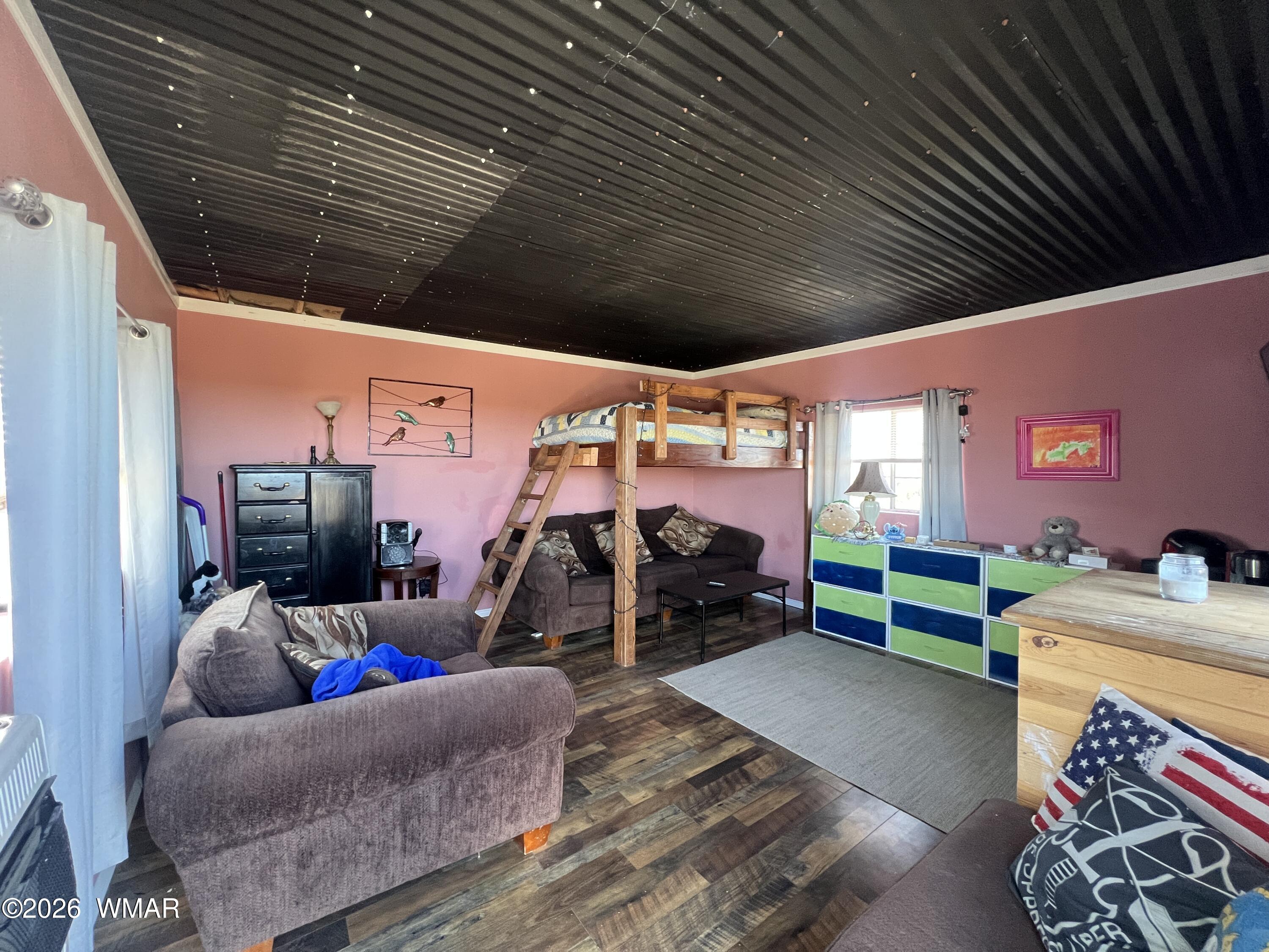 25 North County Road St. Johns, AZ 85936 - Photo 35 of 55 a garage with a couch and a barbeque