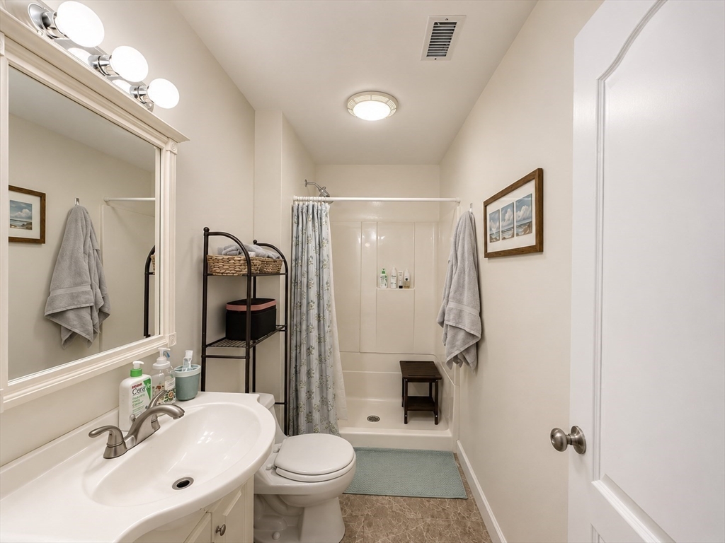 106 Chester Street, Unit 2 Boston, MA 02134 - Photo 7 of 9 a bathroom with a sink toilet and shower