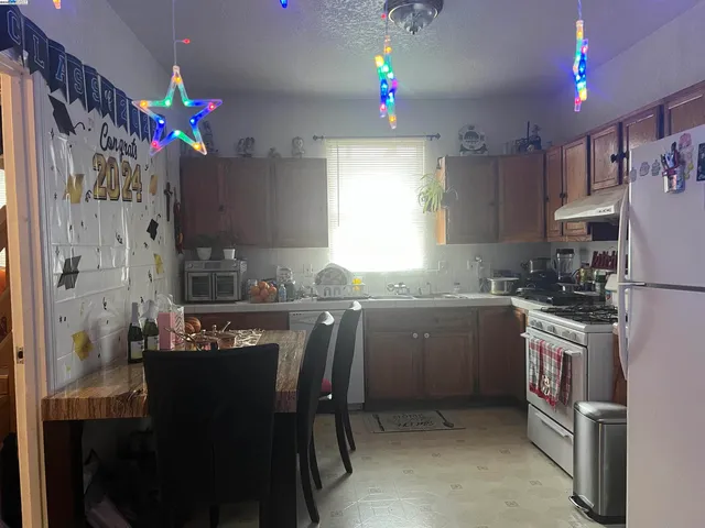 a kitchen with granite countertop a sink stainless steel appliances and cabinets