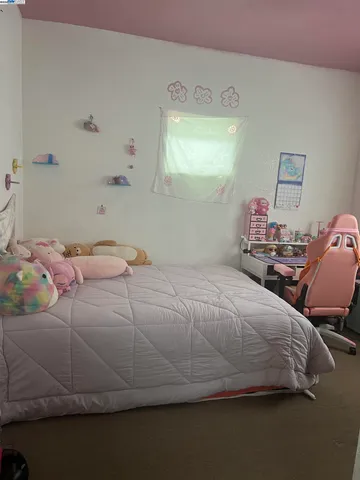 a bedroom with a bed and window