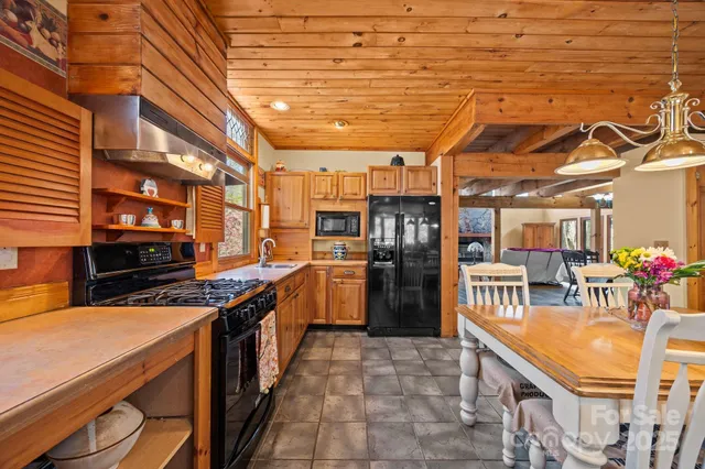 a kitchen with stainless steel appliances granite countertop a sink and cabinets