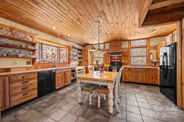 a kitchen with stainless steel appliances granite countertop a stove a sink dishwasher and cabinets with wooden floor