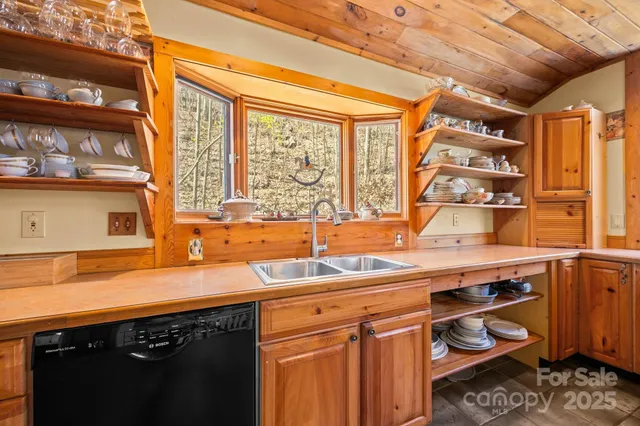 a view of a patio with a table and chairs and couches with wooden floor