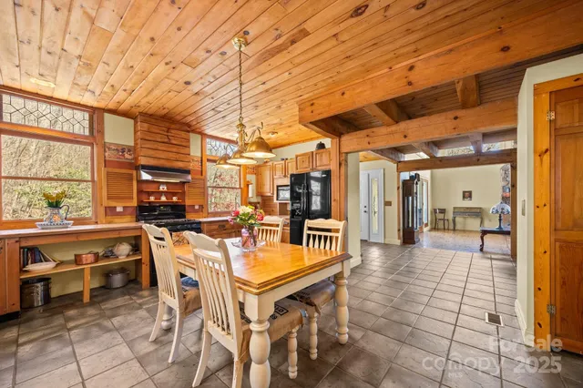 a dining room with furniture and kitchen view