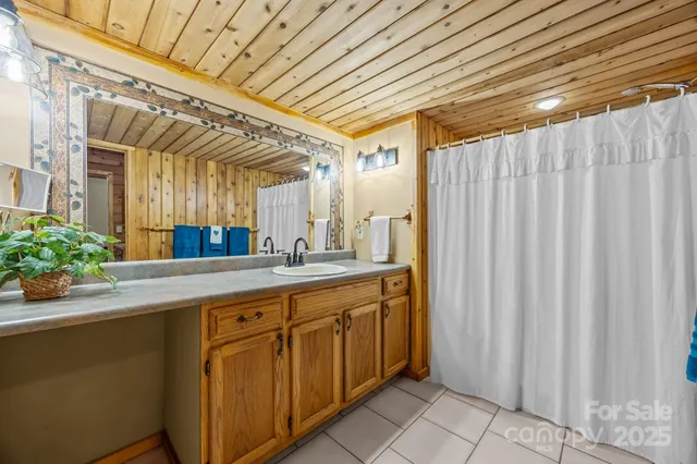 a view of a hallway with dining area and chandelier