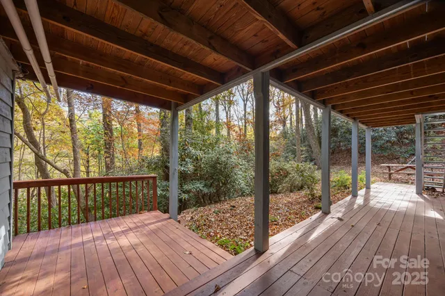 a view of a two room with wooden floor and outdoor seating