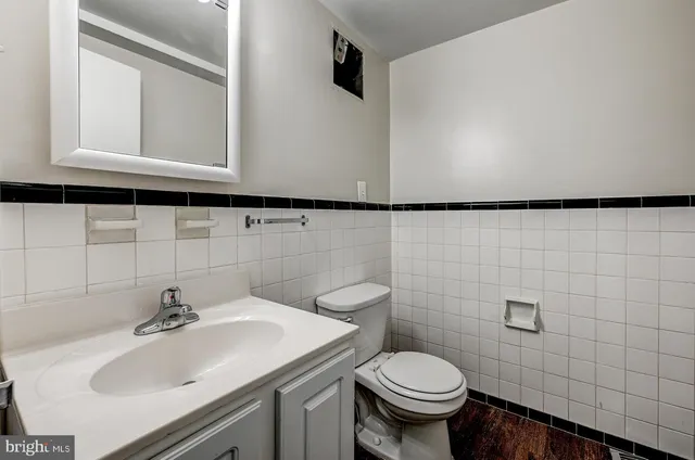 a bathroom with a sink a toilet and mirror