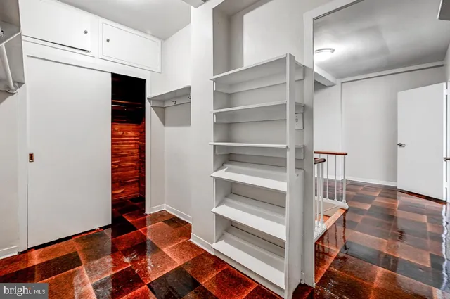 a view of walk in closet with empty racks