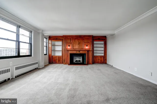 an empty room with furniture and a fireplace
