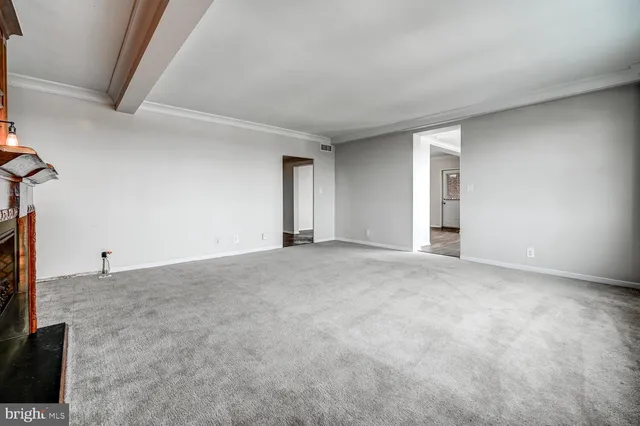 a view of an empty room with a fireplace
