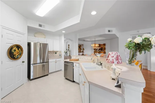 a kitchen with a sink a refrigerator and a stove