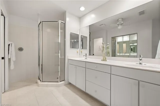 a bathroom with double sink and a mirror