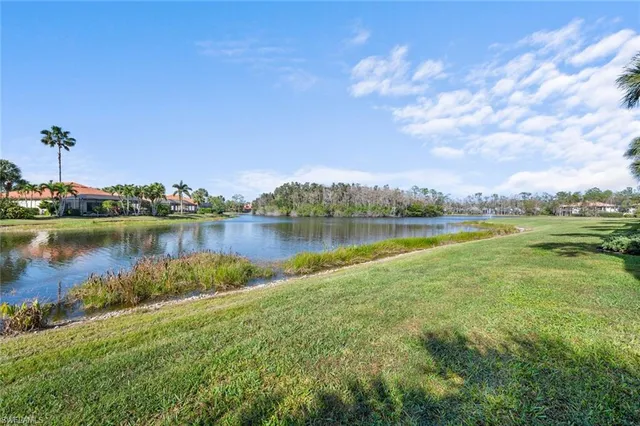a view of a lake with houses in the back