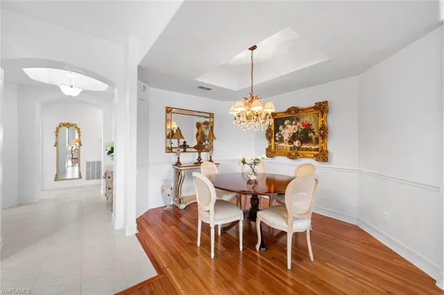 a view of a dining room with furniture wooden floor and chandelier