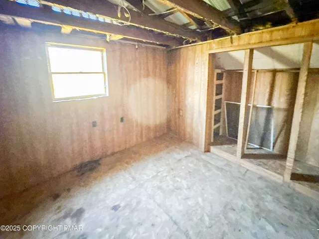 a view of a room with wooden walls