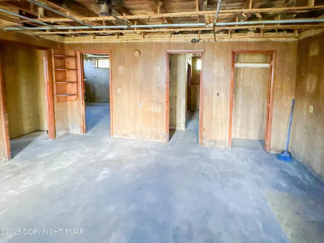 a view of a hallway with wooden walls