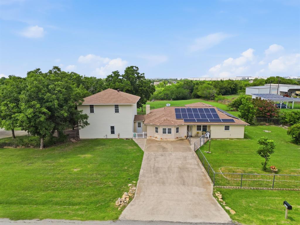 1235 Maxwell Road Haslet, TX 76052 - Photo 2 of 36 Expansive property featuring a concrete driveway, established fencing, and a combination of single-story and two-story structures