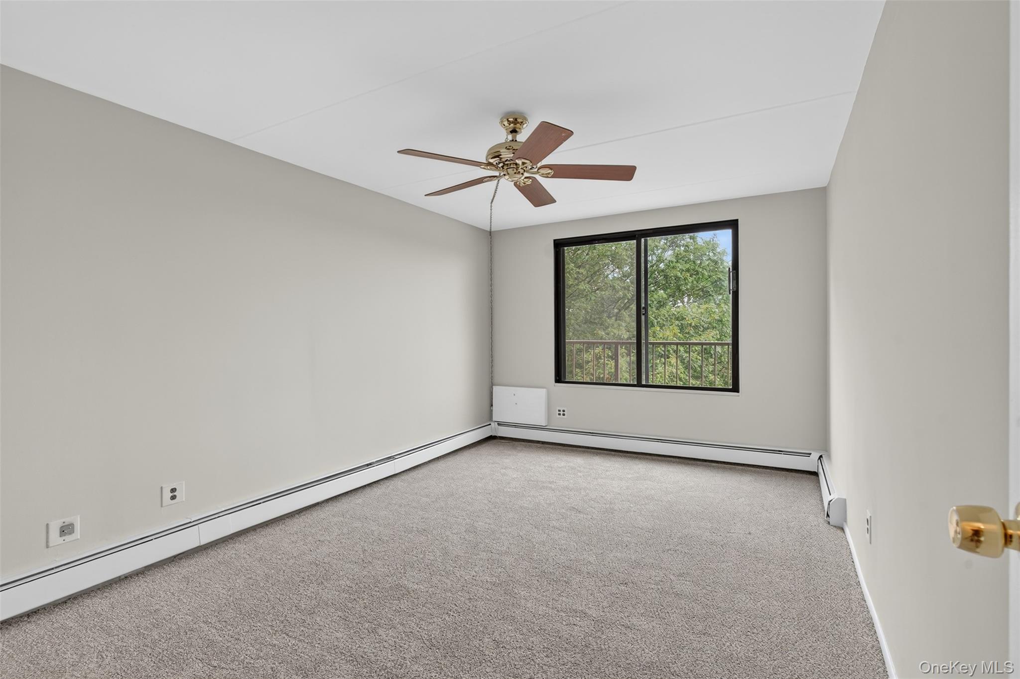 150 Overlook Avenue, Unit 7F Peekskill, NY 10566 - Photo 14 of 24 an empty room with windows and fan