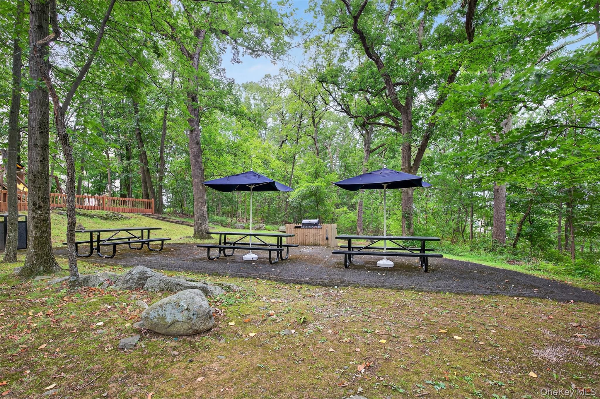 150 Overlook Avenue, Unit 7F Peekskill, NY 10566 - Photo 18 of 24 a view of a outdoor space with a table and chairs under an umbrella