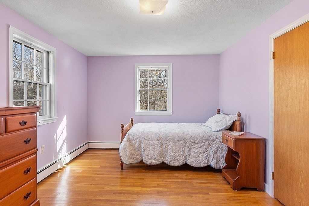 31 Ward Road Sudbury, MA 01776 - Photo 19 of 26 a bedroom with a bed and wooden floor