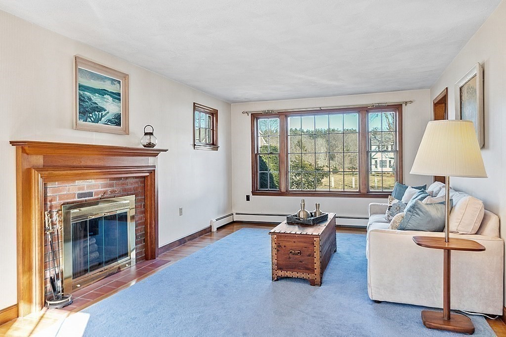 31 Ward Road Sudbury, MA 01776 - Photo 8 of 26 a living room with furniture and a fireplace