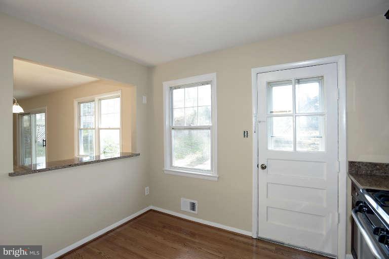 3816 Littleton Street Silver Spring, MD 20906 - Photo 4 of 21 a view of an empty room with wooden floor and a window