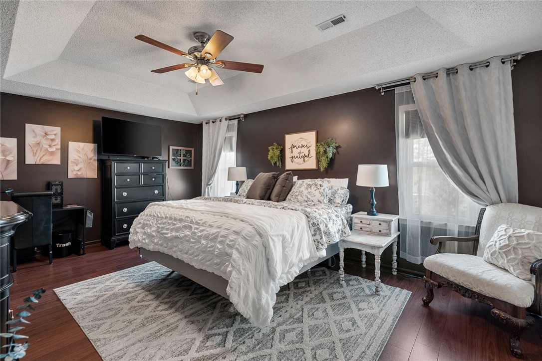 112 C-10-220 Anderson, SC 29621 - Photo 25 of 45 Relax in this inviting bedroom, featuring rich hardwood floors and a striking tray ceiling.