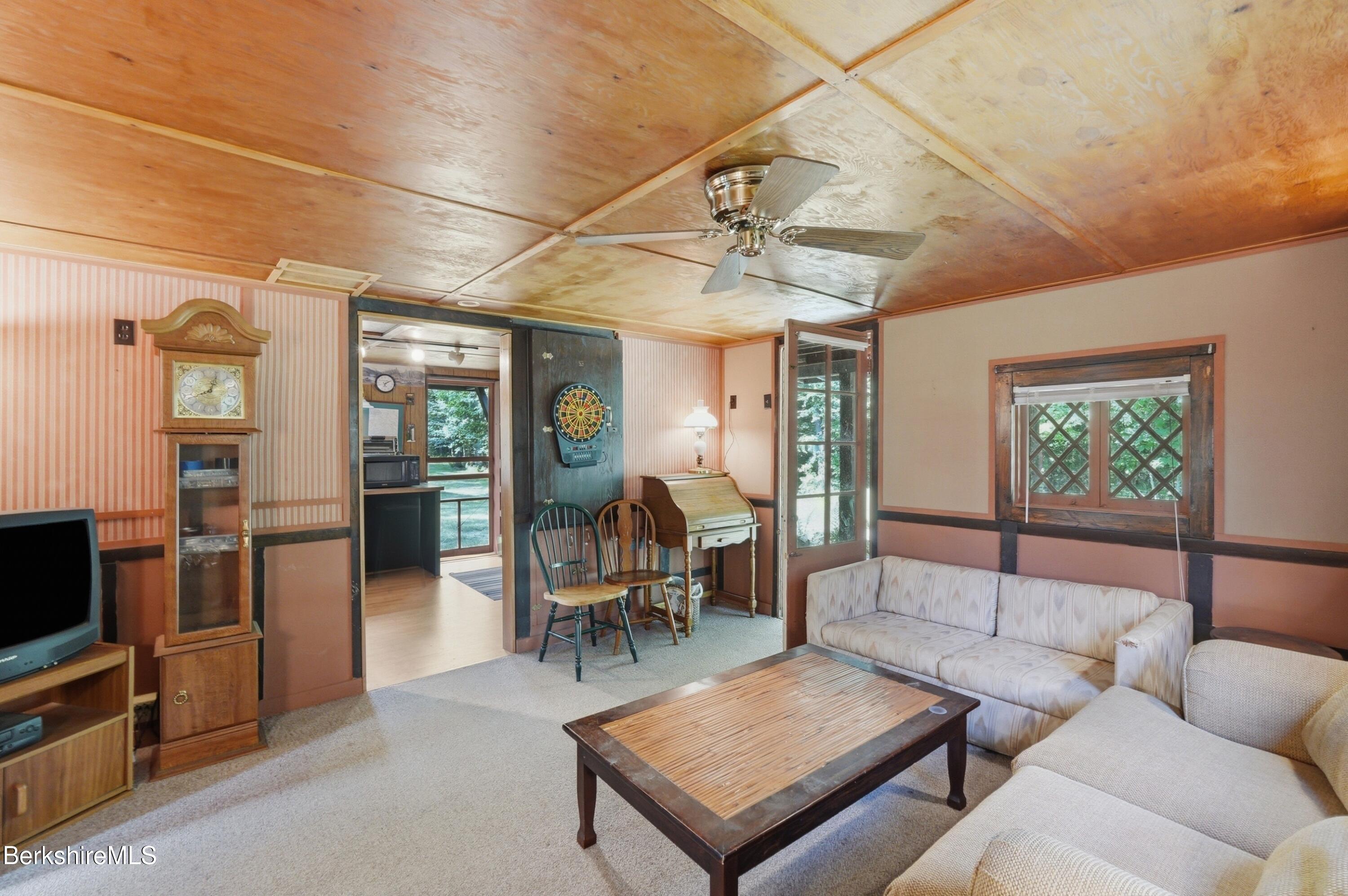 68 Curtin Road Peru, MA 01235 - Photo 29 of 38 a living room with furniture a flat screen tv and a table