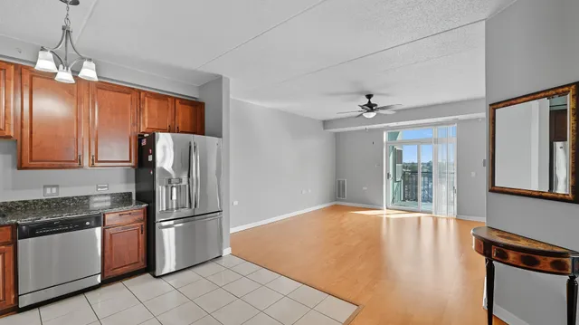 a kitchen with refrigerator and window
