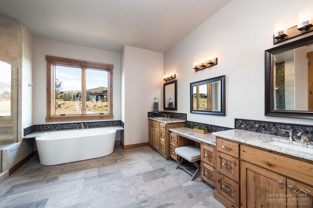 15920 South W Brasada Ranch Road Powell Butte, OR 97753 - Photo 9 of 25 a spacious bathroom with a tub double sink window and mirror