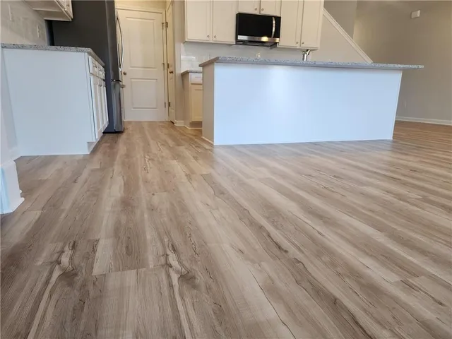 a view of kitchen with wooden floor