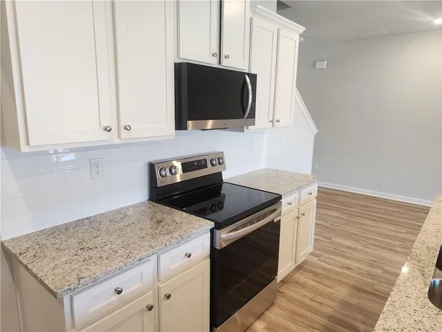 a kitchen with appliances and cabinets