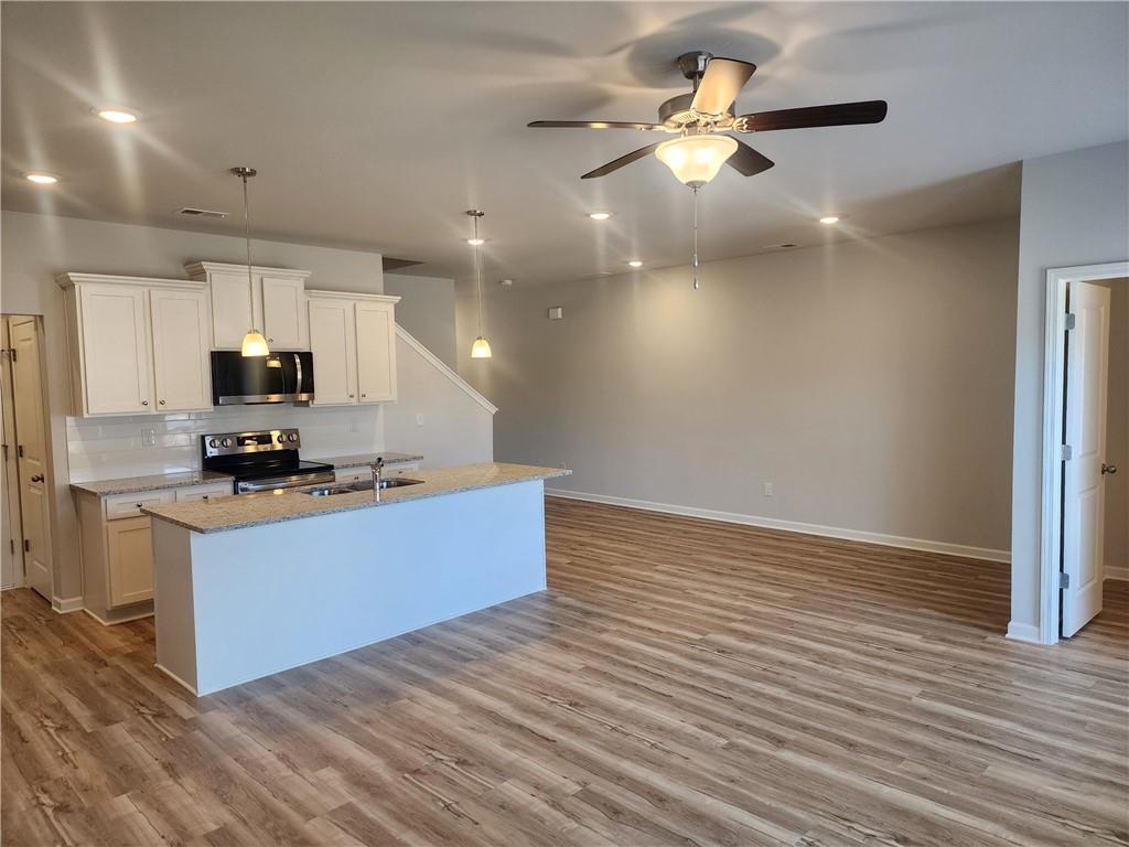 832 Cygnet Lane Grayson, GA 30017 - Photo 19 of 35 a kitchen with stainless steel appliances granite countertop a stove a sink and a refrigerator
