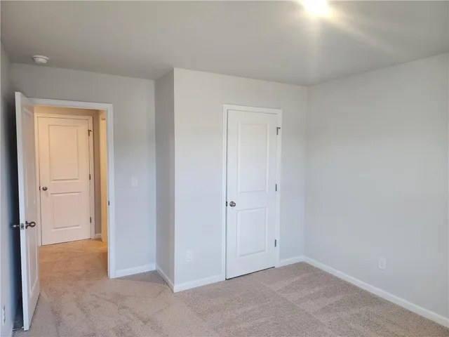 a bathroom with a granite countertop sink a toilet and a mirror