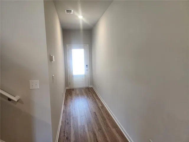 a view of hallway with wooden floor