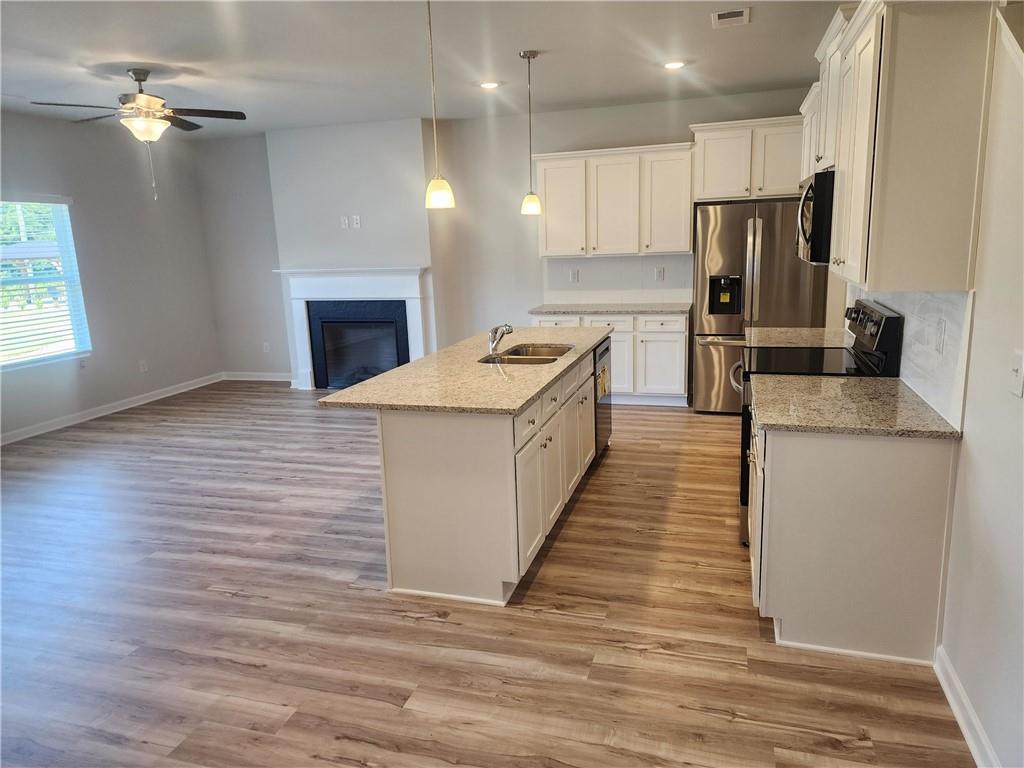 832 Cygnet Lane Grayson, GA 30017 - Photo 7 of 35 a kitchen with stainless steel appliances granite countertop a sink stove and refrigerator