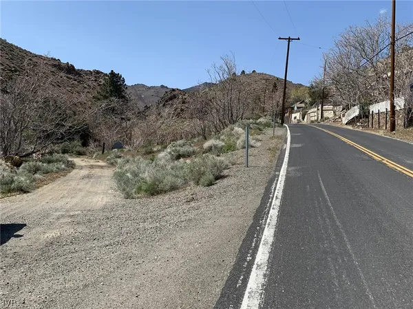 a view of a road with a building in the background
