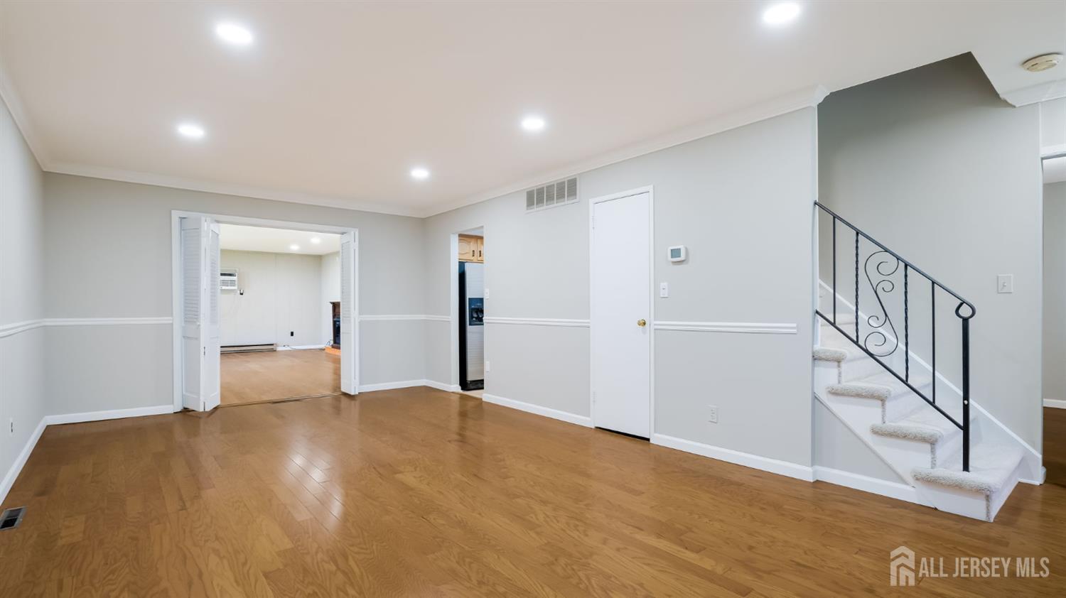 50 Sand Hills Road Kendall Park, NJ 08824 - Photo 5 of 27 a view of an empty room with wooden floor and a window