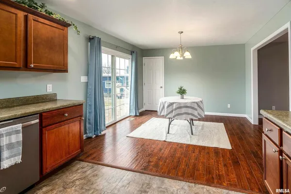 a kitchen with stainless steel appliances wooden floors and wooden cabinets