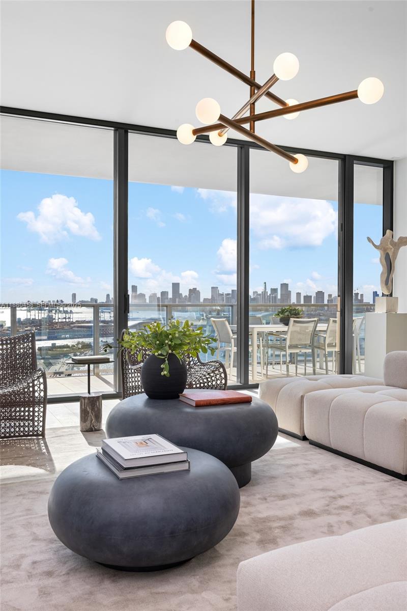 500 Alton Road, Unit 2802 Miami Beach, FL 33139 - Photo 11 of 51 a living room with furniture and a large window