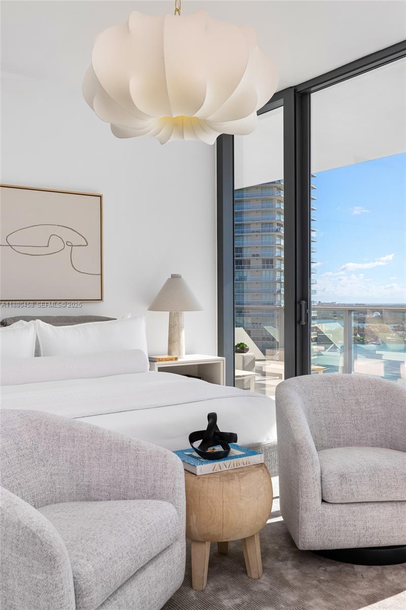 500 Alton Road, Unit 2802 Miami Beach, FL 33139 - Photo 13 of 51 a living room with furniture and a large window