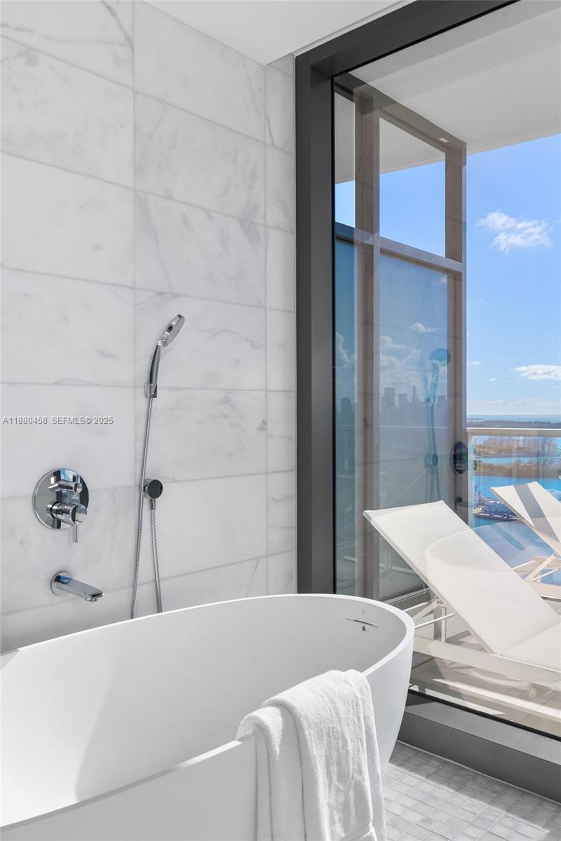 500 Alton Road, Unit 2802 Miami Beach, FL 33139 - Photo 17 of 51 a bathroom with a bathtub and shower