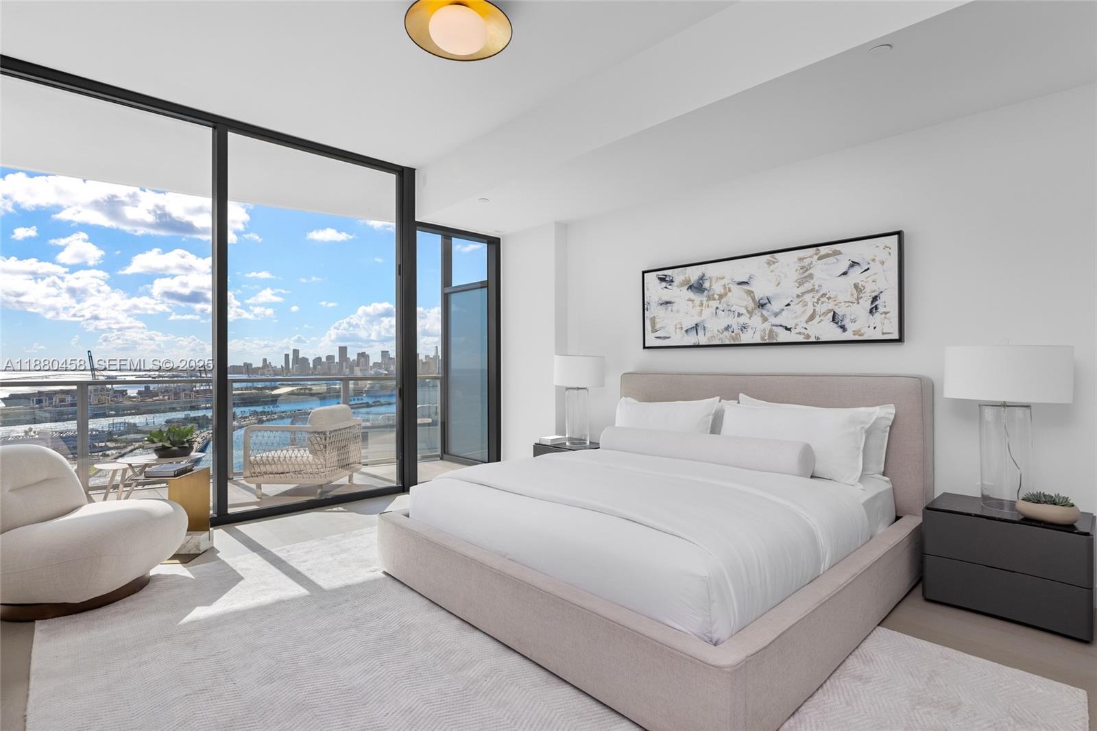 500 Alton Road, Unit 2802 Miami Beach, FL 33139 - Photo 35 of 51 a bedroom with a large bed and a large window with outer view