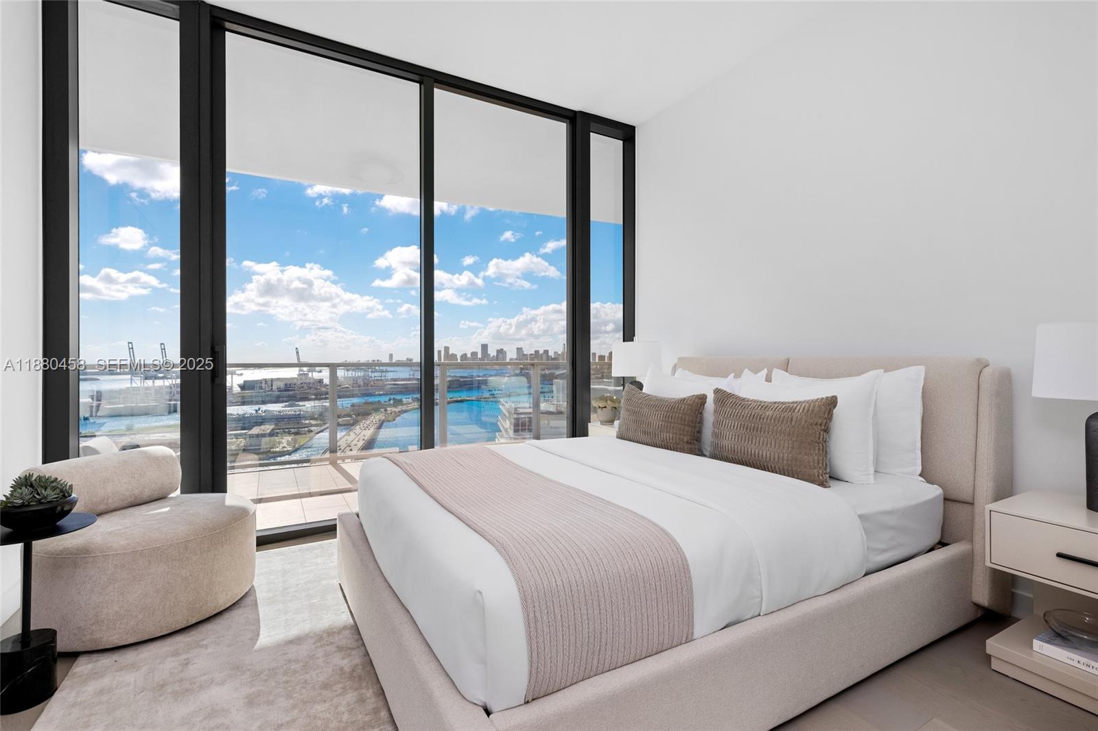 500 Alton Road, Unit 2802 Miami Beach, FL 33139 - Photo 38 of 51 a bedroom with a large window and a bed