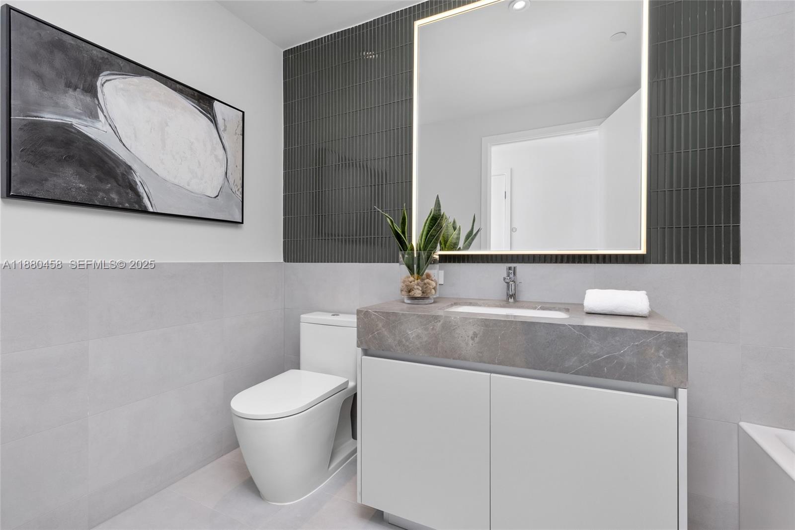 500 Alton Road, Unit 2802 Miami Beach, FL 33139 - Photo 39 of 51 a bathroom with a granite countertop sink and a mirror