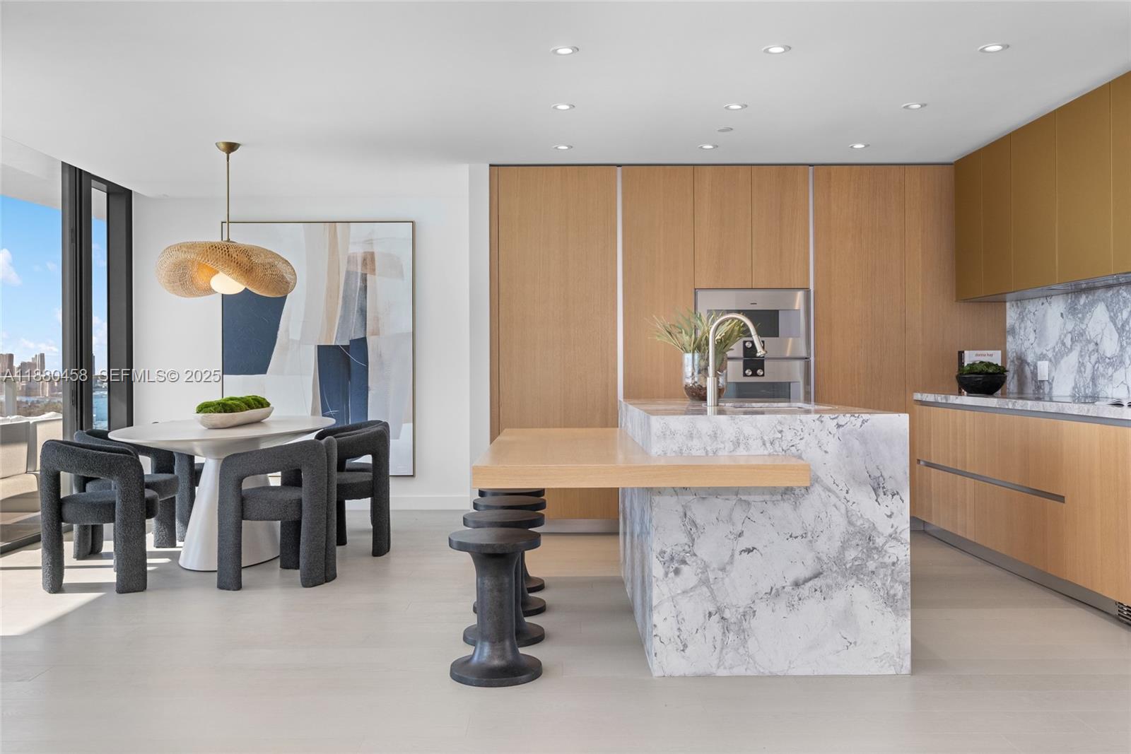 500 Alton Road, Unit 2802 Miami Beach, FL 33139 - Photo 7 of 51 a large kitchen with a table and chairs