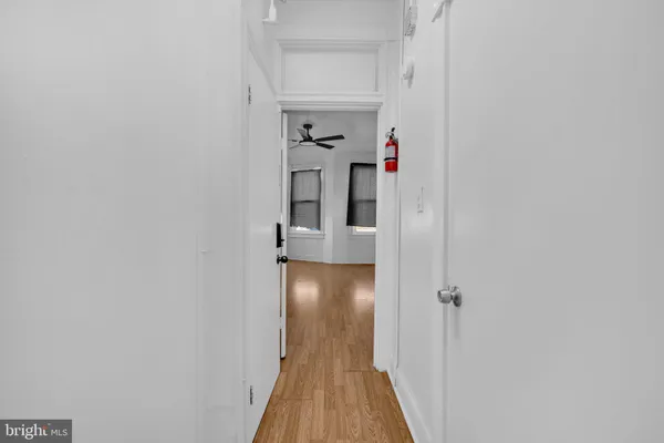 a view of a hallway with wooden floor and entryway