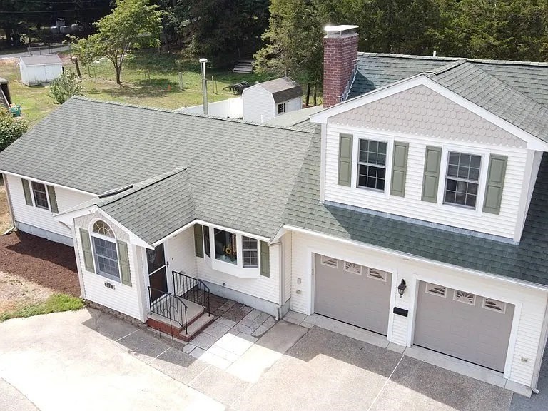 a view of a white house with large windows