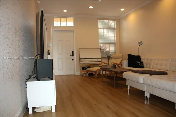 a living room with furniture and wooden floor