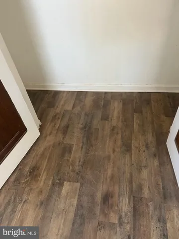 an empty room with wooden floor